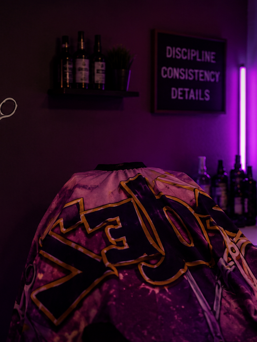 Gold framed mirror reflecting the purple Fadez cape and loyalty cards